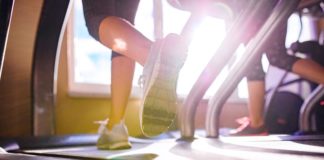 Best Running Shoes for Treadmill in 2020 Close up of legs of two women running on treadmills in a gym, sunny day with top rated shoes