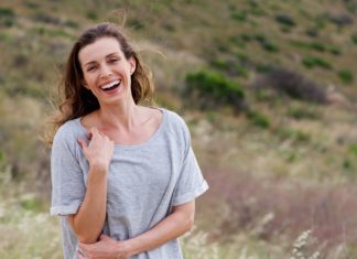 Best Multivitamin For Women Over 40 in 2020 woman laughing thinking about multivitamin for women over 40 years old