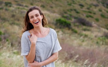 Best Multivitamin For Women Over 40 in 2020 woman laughing thinking about multivitamin for women over 40 years old