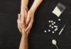 Opiate Withdrawal Timelines, Symptoms and Treatment Drug addict hands asking for help on dark table with cooked heroine, pills, spoon and plastic bag. Concept for drug addiction and International Day against Drug Abuse, top view