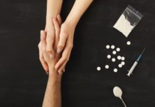 Opiate Withdrawal Timelines, Symptoms and Treatment Drug addict hands asking for help on dark table with cooked heroine, pills, spoon and plastic bag. Concept for drug addiction and International Day against Drug Abuse, top view